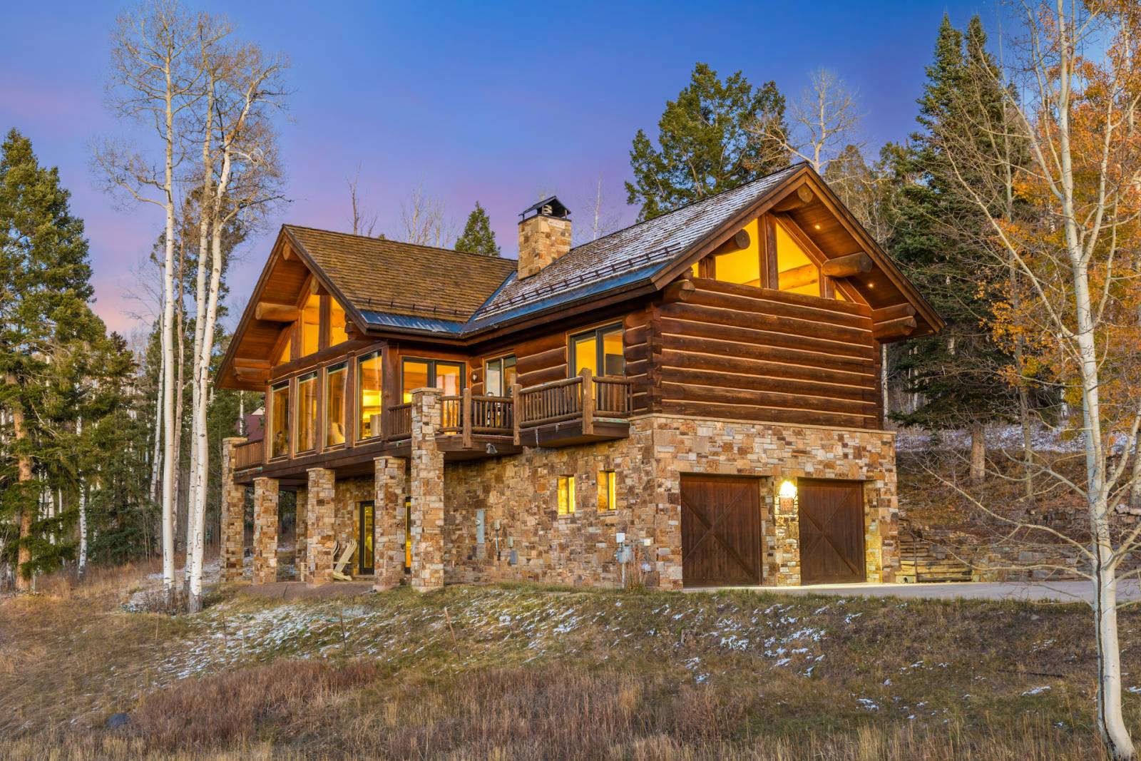 Picture of a house in the forest with bricks and wood