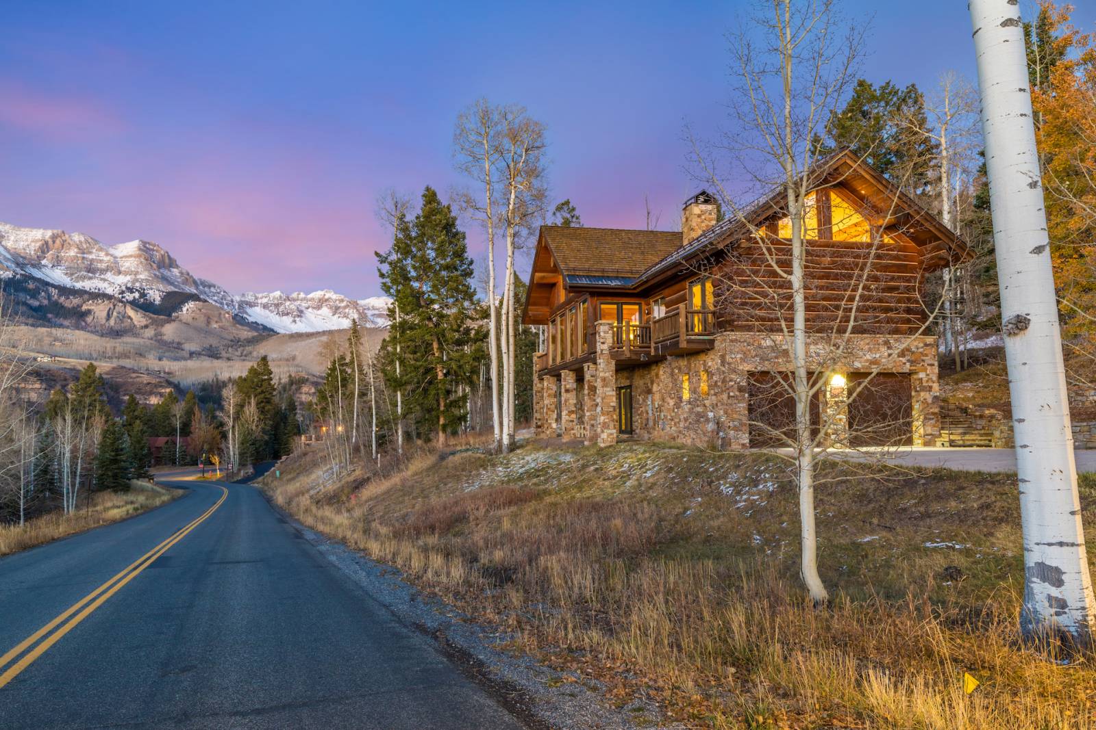 Picture of a house in the forest with bricks and wood